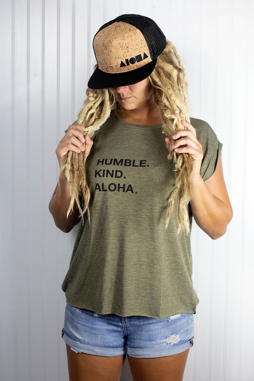 Blond dreadlocked girl wearing a cork Aloha Shapes ® logo snapback hat