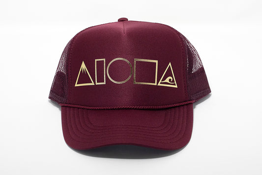 Maroon adult foam trucker hat printed with metallic gold Mauka to Makai Aloha Shapes logo